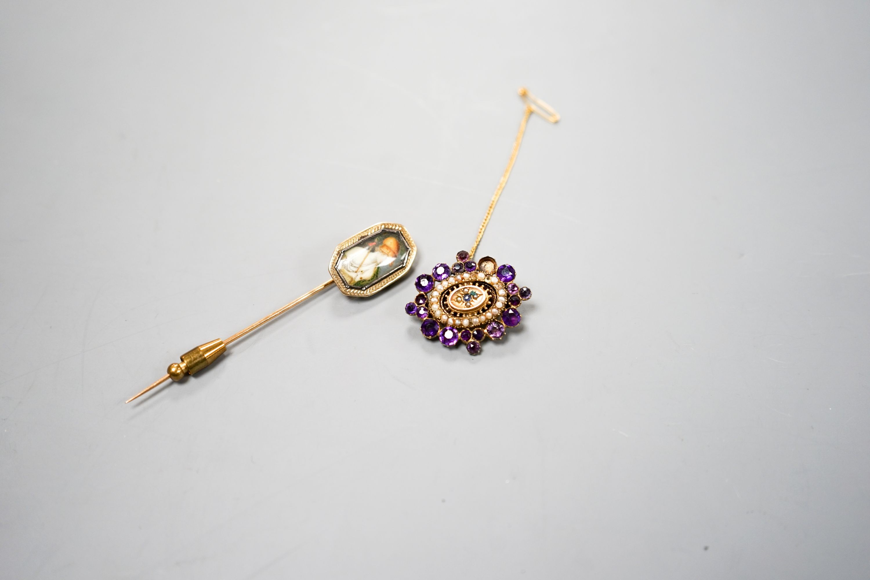 A Victorian yellow metal, amethyst and split pearl set brooch, 31mm and a stick pin.